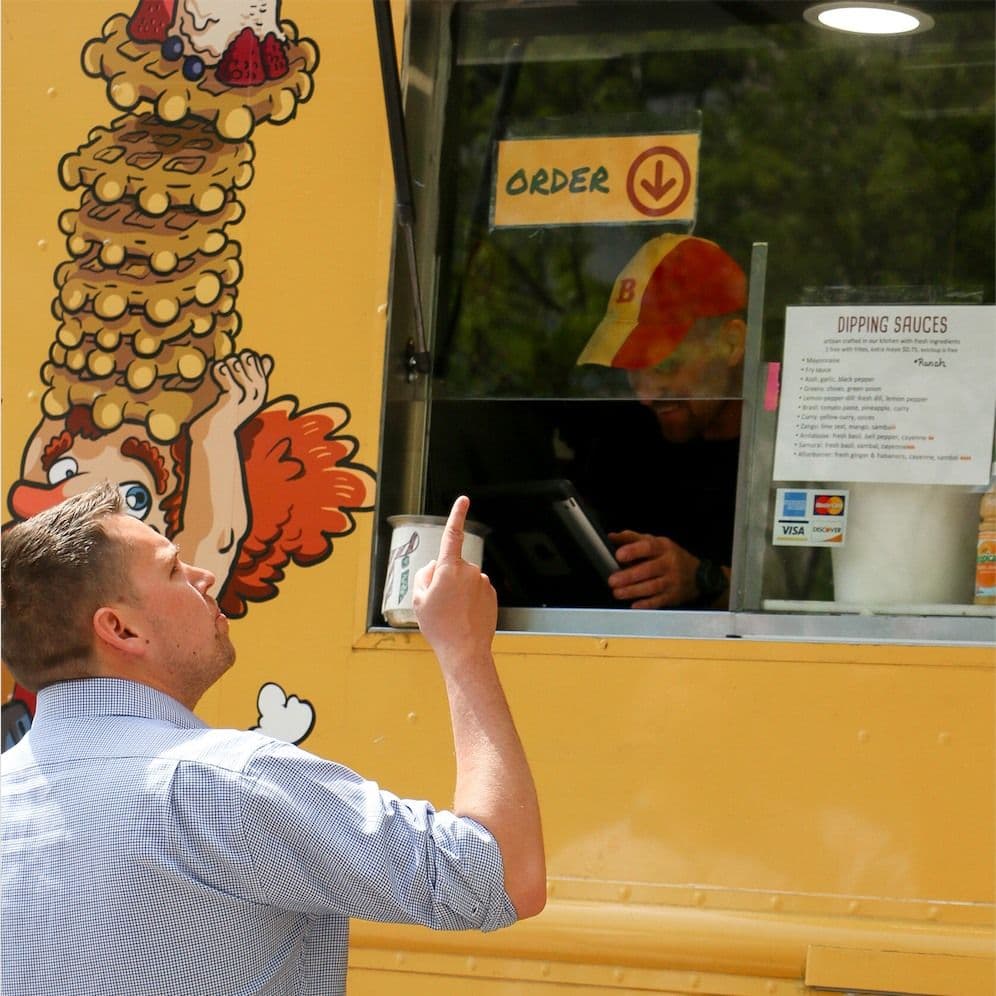 Employee ordering office lunch from a food truck program